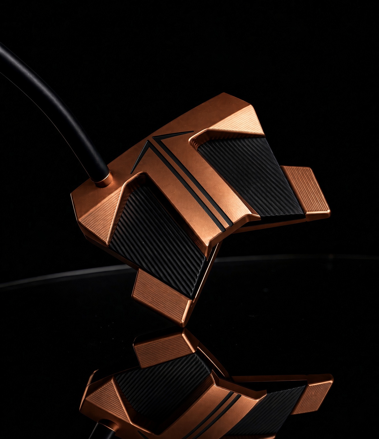 Copper and black mallet putter at address with dual black alignment lines