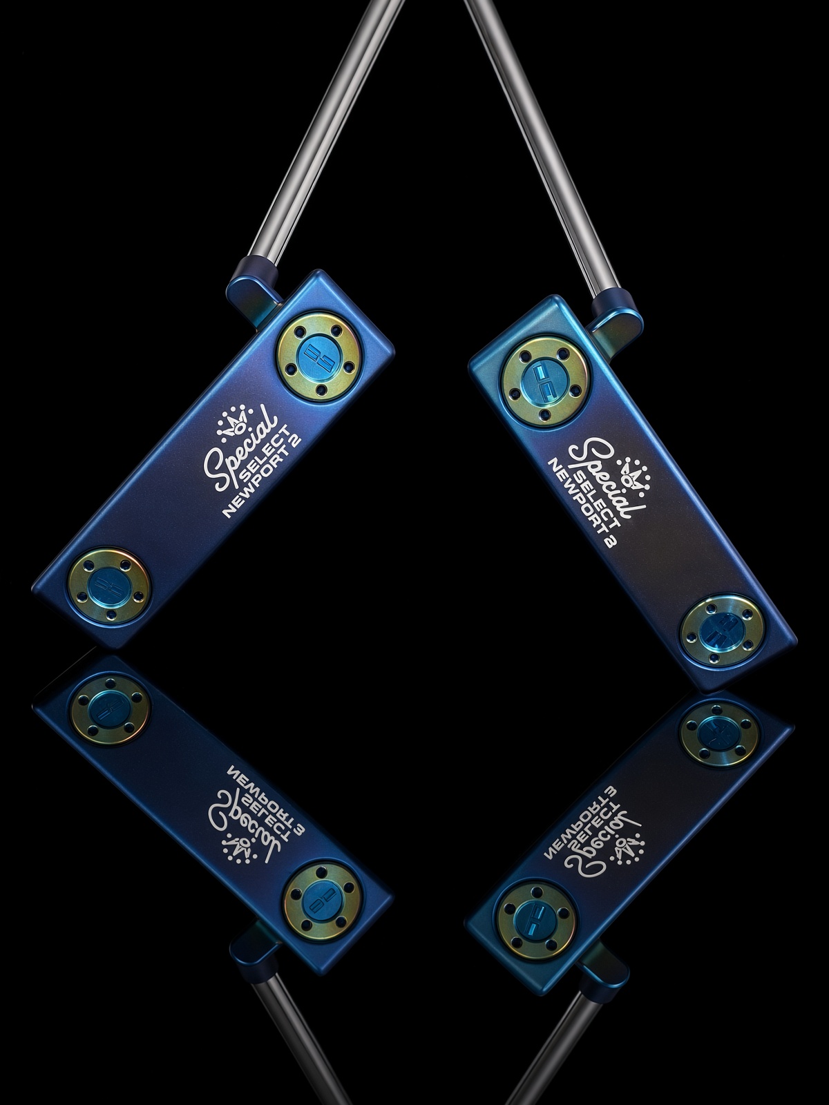 Two blue Scotty Cameron putters with yellow and blue accents