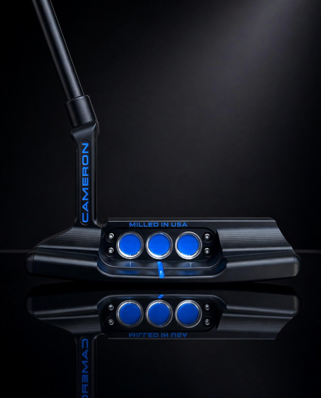 Black Scotty Cameron blade cavity with three blue weight inserts and blue hosel lettering