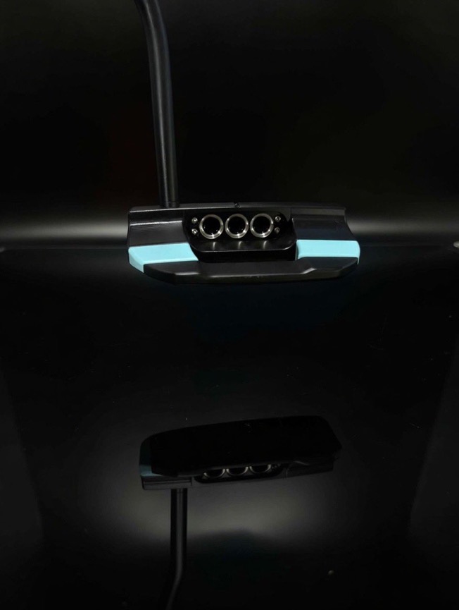 Black Scotty Cameron mallet cavity with three milled silver rings and seafoam blue flanges